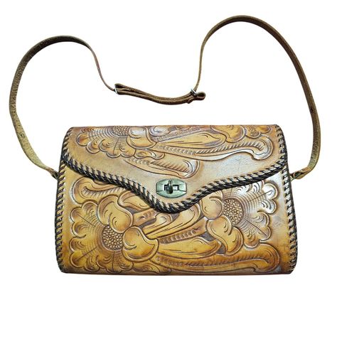 This vintage crossbody bag features an intricately tooled floral design and leather stitching trim, showcasing the craftsmanship of leather artisans. With a secure clasp closure and adjustable strap, it combines functionality with timeless style. The spacious interior offers ample room for essentials, making it suitable for daily use. • Intricately tooled floral pattern • Adjustable strap with snap buttons • Secure clasp closure • Spacious interior Visible wear and discoloration on interior lining, including marks, cracking and scuffs. Stitching on the inner side pocket has come loose on one side. Exterior leather in good condition with minor signs of age. Measurements in pictures are approximate while laying flat, please compare to your favorite fitting item to ensure a good fit. Smoke fr Vintage Crossbody Bag, Leather Artisan, Hand Tooled Leather, Brown Bags, Artisan Craft, Vintage Bags, Leather Tooling, Vintage Accessories, Leather Crossbody Bag