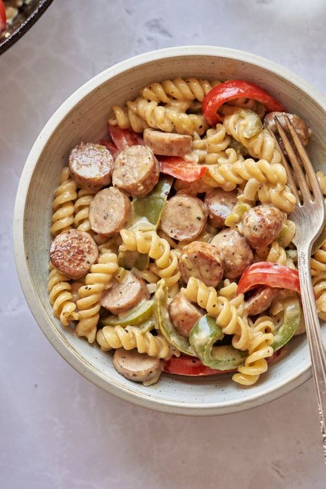 This recipe includes juicy sliced chicken sausage, fresh bell peppers, tender rotini, and a creamy Parmesan sauce. And if you haven't tried chicken sausage, now's the time. It's similar in texture to pork sausage, but tastes like chicken, and is often pre-spiced with peppers, onions, spinach, or cheese. #chicken #sausage #pasta #bellpepper #pepper Chicken Sausage Recipes Pasta, Bell Pepper Pasta, Chicken Peppers And Onions, Sausage And Peppers Pasta, Chicken Sausage Recipes, Chicken Sausage Pasta, Sausage Peppers And Onions, Sausage Pasta Recipes, Creamy Parmesan Sauce