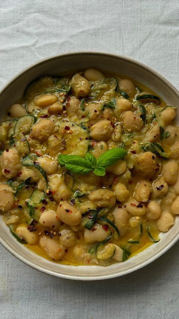 ALFIE STEINER on Instagram: "BRAISED COURGETTE BUTTER BEANS 

A bowl of beans is probably the dish I do most for dinner during the week. it’s so easy to put together, incredibly nourishing + very versatile too. 

I posted this particular bowl of beans on my stories a couple of weeks ago - braised with end of the season courgettes - and you guys went crazy for it…

SO, here it is, with the full written recipe below - enjoy! and as always, let me know if you give it a go 💚

INGREDIENTS (serves 2)

1 large courgette
1 shallot
1/2 red chilli
2 garlic cloves
700g butter beans (+ liquid) @boldbeanco if you can
2 tbsp nutritional yeast
1 tsp miso paste
1 lemon (+ zest)
30g fresh basil
Olive oil
Salt
Pepper

METHOD

1. Slice the courgettes into thin rounds. Warm a good glug of olive oil in pan on Basil Olive Oil, Miso Paste, Butter Beans, Basil Pesto, Red Chilli, Nutritional Yeast, Fresh Basil, Lemon Zest, A Bowl