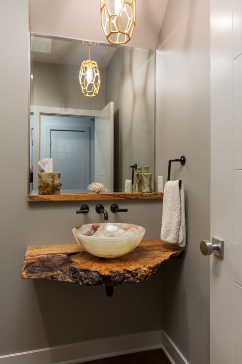 Another wonderful powder bathroom designed by Donna Kirsopp. This bathroom showcases a live edge counter with a vessel bowl. Live edge means what the outside of the tree looks like. The simple onyx bowl allows the wood to stand out. The overall design is simple allowing the showcase pieces to take the glory. Wooden Sink, Powder Bathroom, Wood Countertop, Sink Shelf, Rustic Bathroom Designs, Powder Room Design, Design Remodel, Bathroom Top, Downstairs Bathroom