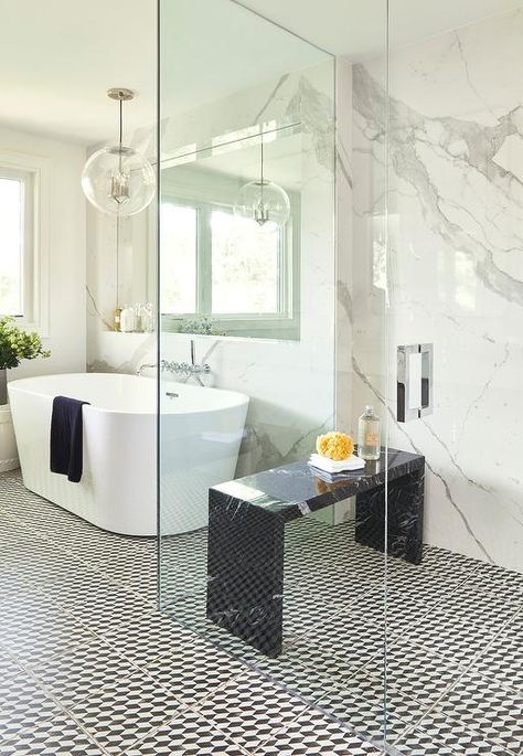 Ali Budd Interiors - A black marble waterfall bench sits on black and white floor tiles in a stunning seamless glass walk-in shower finished with a polished nickel door handle and a marble slab backsplash. White Bathroom Colors, Walk In Shower Designs, Marble Showers, Waterfall Shower, Bad Inspiration, Shower Seat, Transitional Bathroom, Shower Bench, Modern Shower