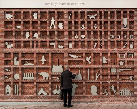 studio wessels boer transforms a blank brick wall into a magnified type case sculpture for an educational urban intervention. Concrete Interiors, Amsterdam Houses, Brick Detail, Brick Art, Brick Arch, Brick Architecture, Exposed Brick Walls, Brick Facade, Brick Patterns