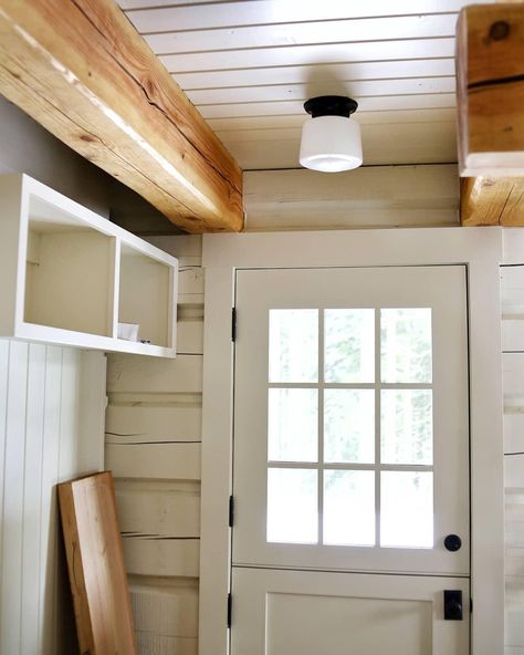 Final electrical started early this morning, yay! I had to head to work before I saw too many of the lights go in, but this one in the mudroom gave me a little thrill - flushmount with a milk glass schoolhouse shade. To the left of that Dutch door will be a coat rack and boot storage unit, with a few closed cupboards up above. / / . . . simpsondoorco #theblackwoodcabin #blackcabin #dutchdoor #whitedutchdoor #logbeams #tongueandgroovemudroom #tongueandgrooveceiling #tongueandgroove #farrowandball Schoolhouse Lighting, Black Cabin, School House Lighting, Tongue And Groove Ceiling, Schoolhouse Electric, Boot Storage, Hidden Rooms, Dutch Door, Cabin Life