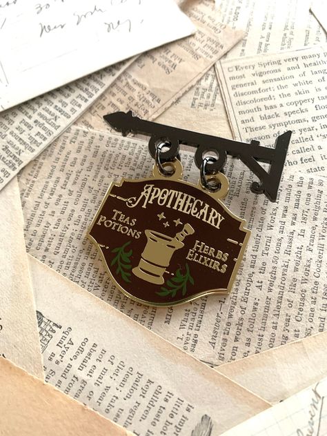 Apothecary shop sign enamel pin. Perfect for any fan of vintage and antique style. . #Apothecary_Shop #Cosplay_Jewelry #Enamel_Pin_Collection #Spice_Cabinet Apothecary Shop, Enamel Pin Collection, Spice Cabinet, Shop Sign, Artist Alley, Cabinet Ideas, Cute Pins, Shop Signs, Deck Of Cards