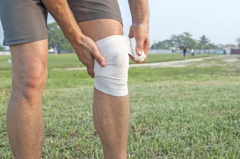 A man is wrapping an injured knee. Knee Problem, Bad Knees, Knee Exercises, Bonnie Bennett, Knee Support, Caroline Forbes, Knee Brace, Knee Injury, Low Impact Workout