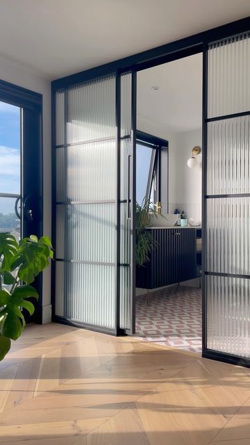 40 Trendy Fluted Glass Home Decor Ideas - DigsDigs Bathroom Glass Door Partition, Reeded Glass Interior Door, Fluted Glass Partition Sliding Doors, Glass Wall Bathroom Bedroom, Glass Separation Wall, Glass Wall Partition Design, Sliding Glass Door Bedroom, Ribbed Glass Door, Bathroom Glass Partition