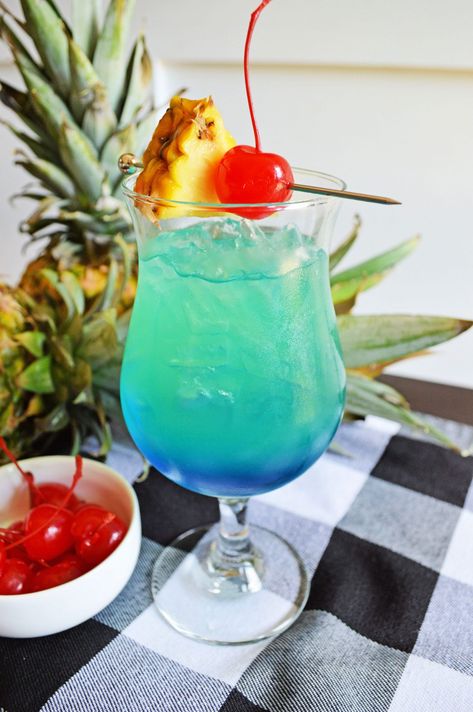 Tropical Blue Hawaiian Cocktail Blue Hawaiian Cocktail Recipes, Blue Hawaiian Drink Recipe Pitcher, Frozen Blue Hawaiian Drink, Blue Hawaiian Mocktail, Blue Hawaiian Drink, Cocktail Snacks, Blue Hawaiian Cocktail, Holiday Coffee Drinks, Blue Hawaii Cocktail