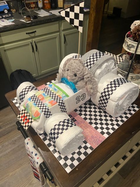 Race car themed diaper cake. Race Car Gender Reveal, Racecar Gender Reveal, Fast And Furious Baby Shower Theme, Baby Shower Race Car Theme, Race Car Theme Baby Shower Ideas, Cars Theme Baby Shower Boys, Race Car Baby Shower Theme, Race Car Baby Shower Ideas, Car Baby Shower Theme