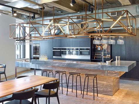 At the Rockwell Group’s New York office for WME/IMG, the demonstration kitchen’s custom lighting truss in painted steel incorporates a mirror, which reflects a mixed-me... Demo Kitchen, Gray Interior Doors, Rockwell Group, New York Office, Corporate Office Design, Family Office, Corporate Interiors, Counter Design, 3d Studio