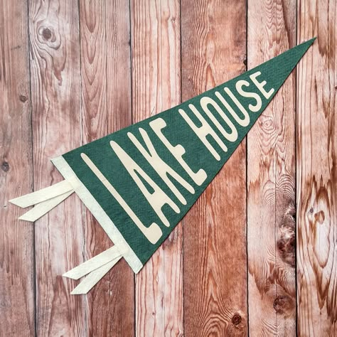 "When the world outside gets too hectic, the Lake House is always calm and serene. Welcome yourself back to your happy place with this pennant wall decoration. This 9x18 pennant is crafted from US-made wool-blend felt, featuring the phrase \"Lake House\". Whether your Lake House is your permanent home, vacation spot, or just a state of mind, you can transform your surroundings into a haven of tranquility with these \"Lake House\" vibes. Makes a great housewarming gift for new homeowners, or a un Lake Camp, Lake House Decor Green, Vintage Lake House, Lake House Wall Mural, Lake House Aesthetic, Lake House Art Wall Hangings, Lake Life Signs Wall Decor, Lake House Interior Design, Pendant Banner