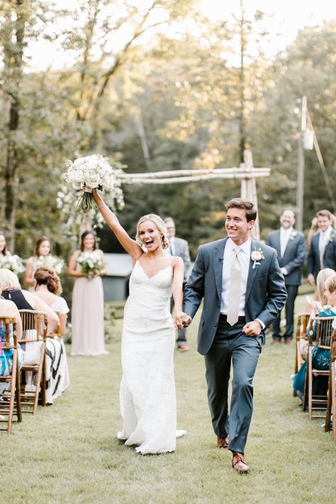 A beautiful blonde bride holds her white rose bouquet in the air as her and her brunette groom walk back down the aisle after their intimate outdoor wedding in Birmingham, AIabama. Captured by Maddie Moore Photography Wedding Photo Ideas Aisle, Groom Aisle Photo, Groom Looking At Bride Down Aisle, Wedding Photography Walking Down Aisle, End Of Isle Wedding Photo, Walking Back Down The Aisle Photos, Wedding Aisle Poses, End Of Aisle Wedding Photo, Aisle Photos Wedding