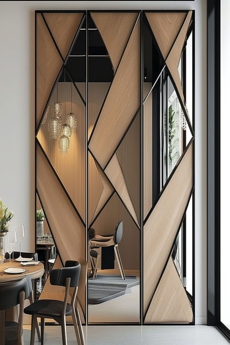 A modern dining room with a large geometric mirror wall design divided by wooden strips, reflecting a chic interior. Mirror Wall Design, Wall Partition Design, Mirror Interior Design, Wall Panel Design, Mirror Design Wall, Foyer Design, Room Partition Designs, Partition Design, Living Room Design Decor