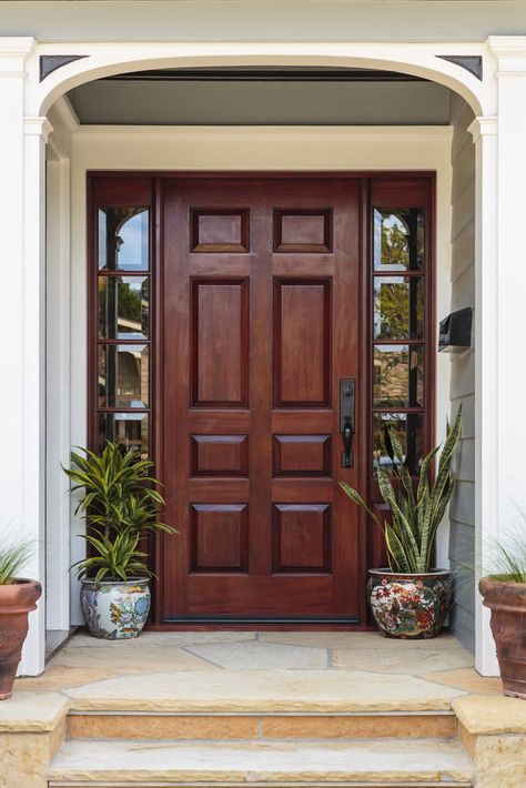 Flagstone entry stairs lead to this dark wood front door that's flanked by mirrored side panels. It is accented with a pair of hand painted ceramic pots. Wooden Front Doors, Wood Front Doors, Entrance Door Design, Wooden Door Design, House Front Door, Main Door Design, Front Door Design, House Doors, घर की सजावट