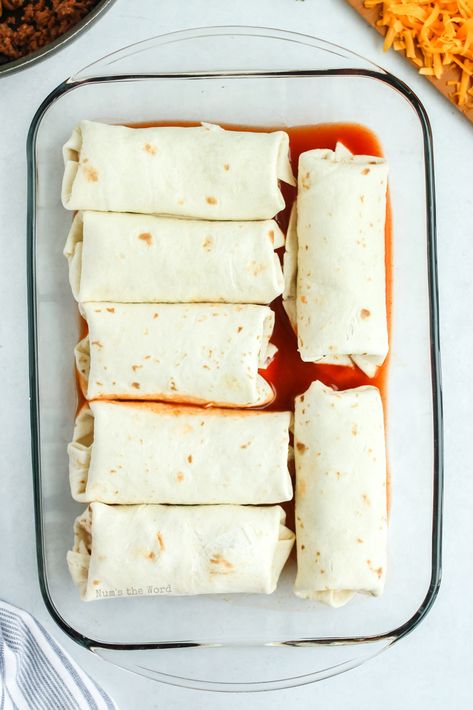 Wet Burritos are an easy weeknight meal everyone will love. Baked in enchilada sauce for extra flavor, this tasty dish also makes a great freezer meal! #burritos #groundbeef #wetburritos #enchiladasauce #recipe #numstheword #ovenbakedburritos #easybakedburritos #freezermeal Easy Baked Burritos, Wet Burrito Casserole, Sheet Pan Burritos, Frozen Burrito Enchilada, Easy Wet Burrito Recipe, Wet Burrito Recipe, Wet Burrito Recipes, Burritos Recipes, Baked Burritos