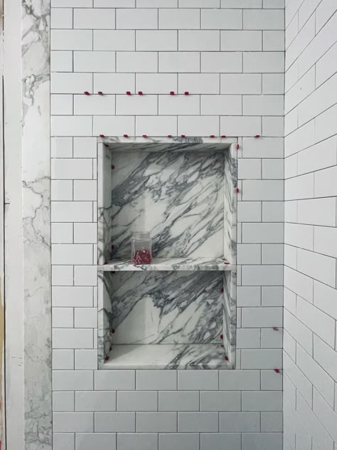 Work in progress, calacatta marble shower niche surrounded by 4x6 subway tiles Marble Shampoo Niche, Marble Bathroom Niche, Marble Shower Shelf, Marble Shower Surround, Marble And Subway Tile Bathroom, Shower Niche Marble, Quartz Shower Niche, Long Shower Niche, Double Shower Niche