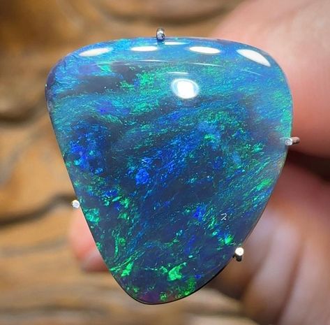 A gorgeous, Solid Black Opal from Lightning Ridge, NSW with a quality finishing polish. Displaying vibrant green and blue colouration on an N1 Black Opal body tone. Cut to a freeform cabochon. Great size to make a ring or pendant. Total weight - 4.8cts Area of Mine - Lightning Ridge NSW, Australia  Dimensions - 16.2mm x 14.9mm x 3.7mm Shape - freeform Colours - green, blue Extras - Free International Airmail / shipping automatically applied when purchasing this item and/or bundling with any other purchase.