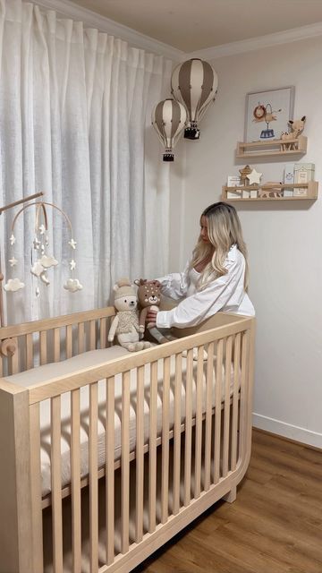 Ani Goulayan on Instagram: "Decorate my nursery with me 🩵 Tags for everything below: I’ll also post direct links in stories 🫶🏼 Furniture: RH baby and child Shelves, wooden toys and books on my Amazon storefront Rug: @westelm Hot air balloon & paintings: @etsy Giraffe: @potterybarnkids Drawers and organizers: @ikea Knitted animals: @cuddleandkind Stars and moon mobile: @etsy Glider chair: @worldmarket Now we’re finally ready for baby to come 🫶🏼" Nursery Room Hot Air Balloon, Ballon Nursery Decor, Hot Air Balloon Baby Nursery Theme, Nursery Ideas Hot Air Balloon, Gold Baby Nursery, Hot Air Balloon Nursery Decor, Nursery Aesthetic, Nursery Idea, Moon Mobile