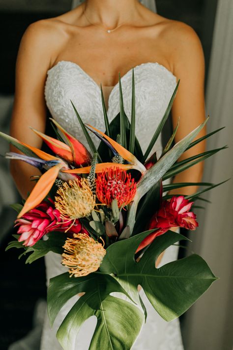 Florida Bride in Lace and Illusion Strapless Wedding Dress Holding Tropical Floral Bouquet, Yellow and Red Pincushion Proteas, Pink Ginger, Birds of Paradise, Monstera Palm Tree Leaves | Tampa Bay Wedding Photographer Amber McWhorter Photography Hawaiian Floral Bouquet, Unique Tropical Wedding Ideas, Birds Of Paradise Bridal Bouquet, Green Tropical Bouquet, Olive Green Tropical Wedding, Bird Of Paradise Bridal Bouquet, Tropical Flowers For Wedding, Wedding Tropical Bouquet, Birds Of Paradise Boutonniere