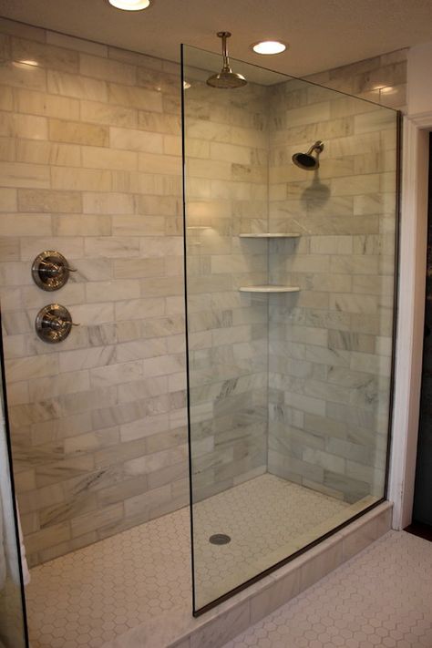 Jennifer Brown - Amazing glass walk-in shower features carrera marble tiles shower surround, rain shower head, corner shower shelves and white hex tile shower floor. Makeover Kamar Mandi, Small Bathroom With Shower, Walk In Shower Designs, Master Shower, Master Bath Remodel, Decor Baie, Bathroom Shower Tile, Bathroom Remodel Shower, Bathroom Remodel Designs