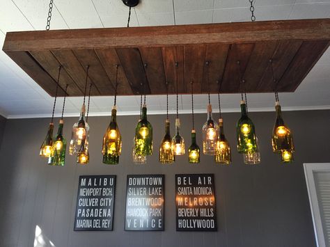 DIY wine bottle chandelier. Bottles Chandelier, Beer Bottle Lights Hanging, Wine Bottle Light Fixture, Bottle Light Fixture, Beer Bottle Chandelier, Gin Bottle Lights, Wine Bottle Chandelier, Diy Wine Bottle, Bottle Chandelier