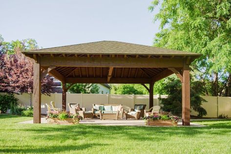 The gentle slope of a hip roof with its trapezoidal sides and pyramid-like elegance is a graceful traditional design that pleases the eyes and can be constructed in a combination of various unique styles. The hip roof, also referred to as a hipped roof is a symmetrical rectangular Outdoor Pavillion Ideas, Pavillion Ideas, Outdoor Pavillion, Hipped Roof, Pavilion Plans, Timber Pergola, Modern Gazebo, Wooden Gazebo, Outdoor Pavilion