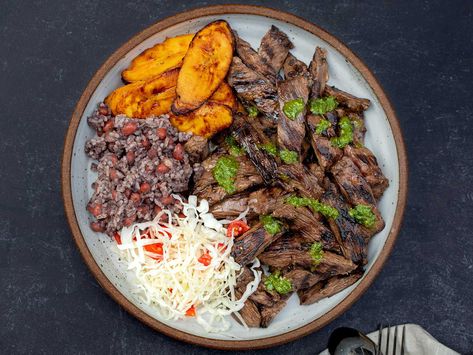 This grilled skirt steak—a beloved staple at Nicaraguan fritangas—is infused with the bittersweet flavor of Seville oranges. Find the recipe here. Nicaraguan Recipes, Nicaraguan Food, Carne Asada Recipes, Grilled Skirt Steak, Herb Salad, Ribs On Grill, Grilled Beef, Juicy Steak, Skirt Steak