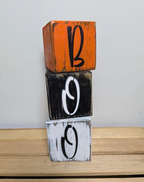 With autumn right around the corner, start collecting your fall decor with 12.17 Creations! Our Wooden Boo Blocks make for the perfect addition to your home all season long.  Our Wooden Boo Blocks have been carefully and thoughtfully assembled from solid wood and hand painted to create reliable, sturdy, and adorable pieces!  We love displaying our blocks around our home all season long, and we are confident you will too!  Our Wooden Boo Blocks also make for the perfect gift for any fall or halloween lovers in your life.  This piece would work perfectly in all areas in your home, and adds warmth and seasonal cheer to any environment! Each block measures 3.5 x 3.5 inches Block Halloween Decor, Wood Block Diy Projects, Wood Block Halloween Decor, Small Wood Block Crafts, Wood Halloween Crafts, Wooden Blocks Decor Craft Ideas, Fall Festival Fundraiser, Halloween Wood Projects, Candle Blocks