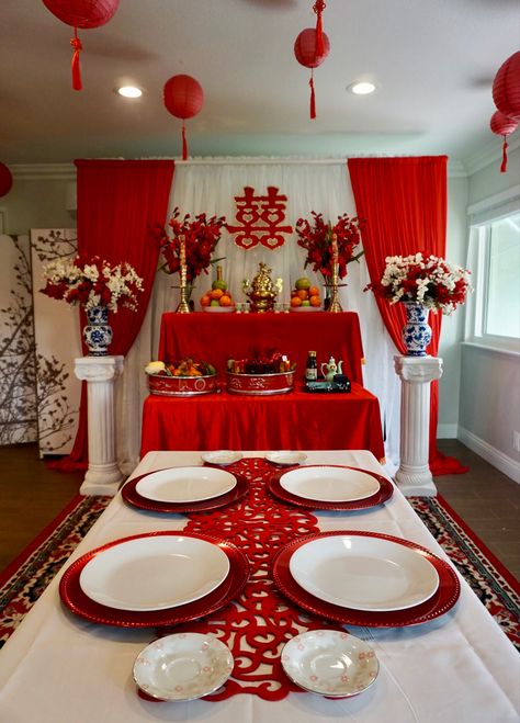 Vietnamese tea ceremony wedding set up. Color scheme is a combination of lucky beight red, white and gold accents. The ceiling has paper lanterns hung from fishing wires giving it a floating effect. Vietnamese Wedding Decorations Tea Ceremony, Vietnamese Wedding Ceremony, Vietnamese Party Decorations, Mexican Vietnamese Wedding, Vietnamese Wedding Reception, Vietnamese Tea Ceremony Decor, Viet Tea Ceremony, Vietnamese Engagement Party, Vietnamese Engagement Ceremony