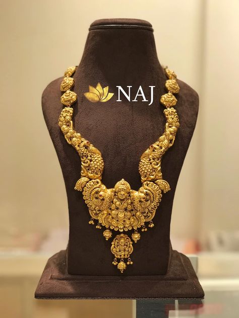 Bridal Jewellery - Traditional Lakshmidevi Haaram in deep nakshi work...Available Only @ NAJ Call or WhatsApp @ 9032041323 or email to mynaj@najindia.com... Available Only @ Naj Jewellery, Nellore.#TANAUSA, #TeluguUSA Gold Aram Designs Latest, Naj Jewellery, Jewellery Traditional, Haram Designs, Necklace Traditional, Temple Jewelry Necklace, Gold Temple Jewellery, Antique Gold Jewelry Indian, Gold Necklace Indian