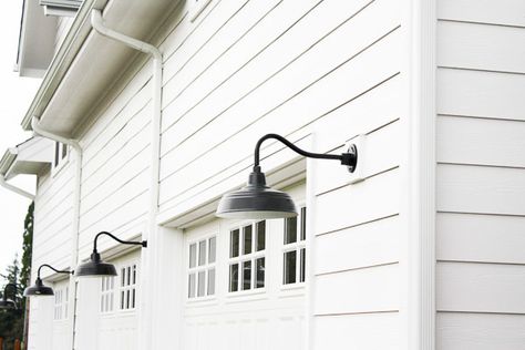 ... white modern farmhouse. And last but certainly not least, are the black gooseneck barnlights on our garage. Barnlights like this are becoming easier and ... Farmhouse Outdoor Lighting, White Modern Farmhouse, House Lighting Fixtures, White Siding, Modern Farmhouse Lighting, Farmhouse Exterior Design, Diy Outdoor Lighting, Club Lighting, Exterior Light Fixtures