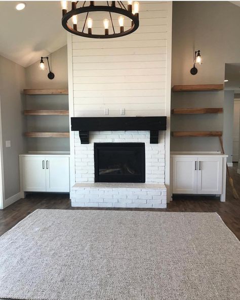 Love the white brick. We want a mantle with a brown reclaimed wood to coordinate with floor color. Built ins on side possibly a barn door to close in t.v. If possible. Shiplap painted white going up to ceiling. We do like the idea of using the color from island in kitchen on the sides of fireplace to connect both rooms. Accent wall if you must. Fireplace And Shelves, Fireplace Built Ins, Farmhouse Fireplace, Store Books, Fireplace Remodel, Seat Storage, Perfect House, Storage Places, Fireplace Ideas