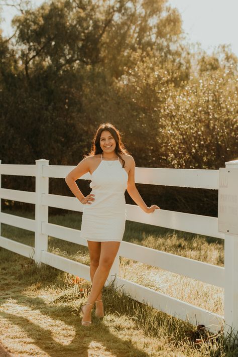 senior graduation girl portraits at golden hour at canyonside community park san diego with a fence and green posing ideas location Graduation Pictures At Park, Graduation Pictures Park, Fence Picture Poses, Fence Photoshoot Posing Ideas, Fence Poses Photography, San Diego Senior Pictures, Fence Photoshoot, Fence Senior Pictures, Senior Picture Ideas On Campus