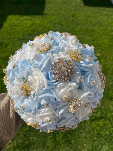 Handmade Quinceañera Bouquet/ Wedding. With Light Blue, Bahama Blue and White Foamy Roses. Finished off with Gold brooches. *Please note brooches can change in style due to availability.* Decor / color combinations can be changed upon request. {This is a made to order Bouquet} Sweet 15 Dresses Quinceanera Light Blue, Light Blue And Gold Wedding Decorations, Light Blue And Champagne Wedding Colors, Light Blue And Gold Quinceanera Theme, Baby Blue And Gold Quinceanera Theme, Light Blue And Gold Quince, Light Blue And Gold Birthday Decorations, Baby Blue And Gold Wedding, Quince Venue Ideas Light Blue