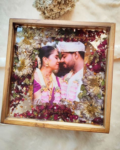 Sealing memories forever ♾️ 💕 My client Abhishek wanted to gift his friends our trending frames and placed order for 2 frames as a post-marriage gift 🎁 Upon receiving a beautiful fresh Lotus mala,we could able to dry them properly with utmost care & attention. To compliment the lotuses, added few bright rose petals & different sizes of pearls which enchanced the piece. And that's how the frame turned into 💕 I personally love how beautifully the floral shades got blended with the couple... Marriage Gift For Best Friend, Marriage Gifts For Couple In India, Resin Gift Ideas, Varmala Preservation, Marriage Gift, Wedding Garland, Marriage Gifts, Garland Wedding, Forever Me