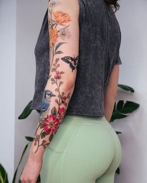 Colored Flower Back Tattoo, Full Color Floral Sleeve Tattoo, Whimsical Garden Tattoo Sleeve, Botanical Sleeve Tattoo Wild Flowers, Colored Nature Tattoo, Mixed Floral Tattoo, Nature Arm Tattoos For Women, Colorful Floral Sleeve Tattoos For Women, Botanical Tattoo Sleeve Colour