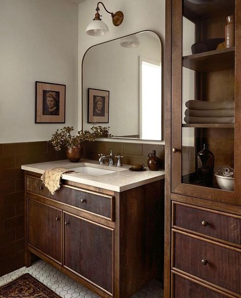 Feb 29, 2024 - Indulge in the elegance of dark red and brown interiors, where sophistication meets warmth in a captivating chocolate-meets-berry hue. Vintage Style Master Bath, Brown Accent Bathroom, Classic Masculine Bathroom, Chocolate Brown Bathroom Cabinets, Double Wood Vanity Bathroom, Maroon Bathroom Decor, Moody European Bathroom, Sophisticated House Interiors, Chocolate Brown Bathroom Ideas