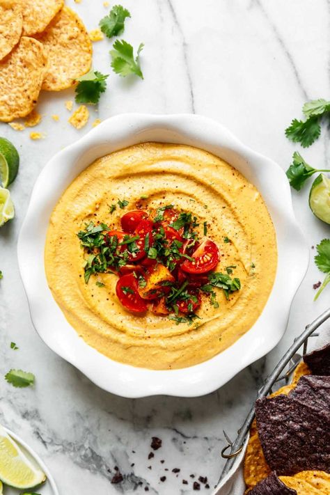 Grab your favorite corn chips, cause creamy, cheesy vegan nacho queso is coming your way! This magical recipe is so good you'll never believe it doesn't contain cheese. Instead, this vegan queso recipe is loaded with healthy whole-food ingredients that pack some nutrition into each bite. Vegan Queso Dip, Vegan Queso, Vegan Nachos, Queso Recipe, Vegan Cheese Sauce, Mexican Spices, Dairy Free Cheese, Sunday Meal Prep, Corn Chips