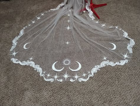 Photographed veil made in Ivory, this 10 foot Cathedral veil has whispy lace and embroidered moons, stars and sun. Can be made with or without a blusher. Can be made in many different colors! The tulle and embroidered stars can come in almost any color, although the wispy lace only comes in Ivory. I love customizing orders! please message with any questions Wedding Veil And Crown, Celestial Wedding Accessories, Alternative Wedding Veil, Witchy Wedding Theme, Alternative Veils Wedding, Unique Veil Ideas, Embroidered Veil Wedding, Sapphic Wedding Ideas, Celestial Veil Wedding