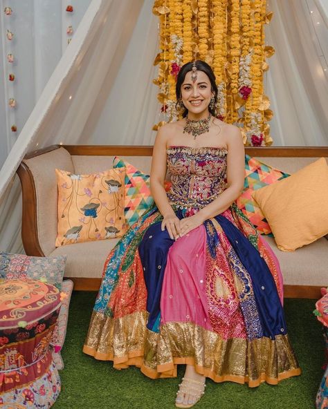 This beautiful bride captured our admiration with her vibrant lehenga adorned with seashell embellishments! Her multicolored attire truly stands out and adds a unique touch to her wedding ensemble. The intricate seashell details enhance the overall design, making it a stunning choice for her special day. We were instantly captivated by the combination of colors and textures, which create a mesmerizing look. Mehendi Looks For Bride, Haldi Ceremony Outfit For Bride Unique, Mehendi Bridal Outfit, Mehendi Ceremony Outfits, Haldi Dress For Bride, Mehendi Outfits For Bride, Sangeet Look, Mehandi Outfits, Haldi Ceremony Outfit