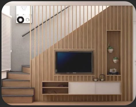 Stairs Tv Wall Living Rooms, Minimalist Living Room With Stairs, Small Living Room Ideas Under Stairs, Tv At Staircase, Tv Against Staircase, Living Room Tv On Stair Wall, Under The Stairs Tv Unit, Tv Wall Design Stairs, Stairs Duplex Ideas