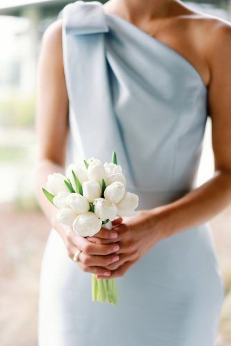 Posey bouquet of white tulips. Small Wedding Bouquet Simple White, Bridesmaid Bouquet Blue Dress, Small White Tulip Bouquet, Wedding Bouquets Bride Tulips, Bridesmaid Lily Bouquet, Hydrangea And Tulip Bouquet, Petite Bridesmaid Bouquet, Small White Bridesmaid Bouquet, Bridesmaid Posey