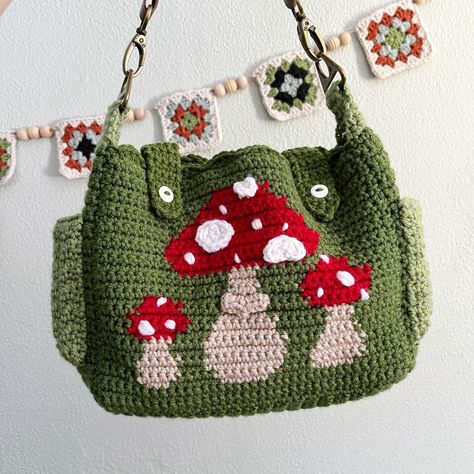 Apparently I haven’t posted the finished version of this bag! It took me way too long to finish it, but it came pretty dang cute. It has adjustable straps, multiple pockets, and the button closures on the front. If you’re at all interested in buying, DM me or head to Etsy or Depop to buy! #mushroompurse #munshroombag #cottagecore #cottagecorecrochet #crochetbag #crochetpurse Crochet Mushroom Purse, Mushroom Purse, Green Cottagecore, Cottagecore Bag, Cottagecore Mushroom, Crossbody Bag Pattern, Crochet Mushroom, Bag Pattern Free, Pinterest Diy Crafts