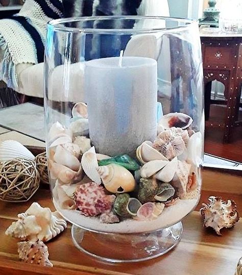 Clear Glass Hurricanes | Decorating Ideas with Candles, Beach Sand, Shells,  more - Coastal Decor Ideas Interior Design DIY Shopping Candle Holder Decor Ideas, Grand Vase Transparent, Beach Theme Candles, Beach Candles, Beach Candle Holder, Vase Filler Ideas, Seashell Display, Koti Diy, Jar Fillers