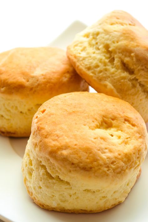 Lemon Scones - What better way to accompany your afternoon tea than with a fresh-baked scone (or six)? Infused with lemon zest, they're excellent with a matching citrus glaze drizzled on top for an extra zing of sweetness. Made with all-purpose flour, baking powder, sugar, salt, lemon peel, butter, eggs, milk or buttermilk | CDKitchen.com Lemon Buttermilk Scones, Lemon Scones Recipe Easy, Milk Scones Recipe, Flavored Breads, Lemon Scones Recipe, Citrus Glaze, Lemon Biscuits, Baking Powder Biscuits, Baking Scones