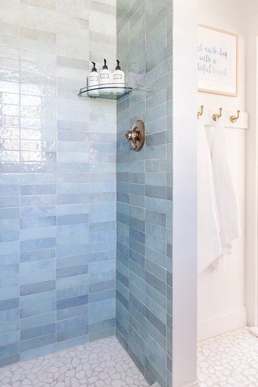 Blue Shower Tile Ideas and Inspiration | Hunker Seafoam Green Tile Bathroom, Bath Shower Combo Tile Ideas, Dave And Jenny Marrs Bathrooms, Bathroom Tile Schemes, Blue Walk In Shower Ideas, Beachy Shower Tile Ideas, Blue Porcelain Tile Bathroom, Blue Zellige Bathroom, Blue And Marble Bathroom