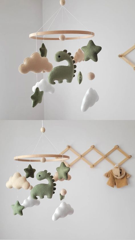 Adorable felt baby mobile featuring a charming green dinosaur. 💚

This baby mobile is meticulously handmade with attention to detail, ensuring a high-quality and delightful addition to your nursery decor. It is crafted using safe and eco-friendly materials, making it a perfect choice for your little one. 🌿 Sage Dinosaur Nursery, Nursery Decor Dinosaur, Cute Dinosaur Nursery, Dinosaur Mobile Diy, Green Dino Nursery, Dinasour Themed Nursery, Baby Nursery Dinosaur Theme, Nursery Ideas Dinosaur Theme, Subtle Dinosaur Nursery