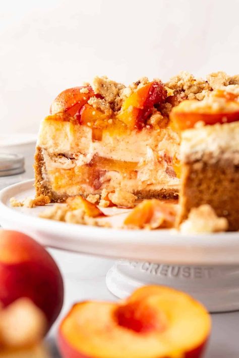 This tall, luscious Peach Cobbler Cheesecake is bursting with fresh peach flavor from summer's sweetest fruit. A buttery graham cracker crust and creamy cheesecake filling are the perfect complement to roasted peaches and a crunchy crumble topping. Peach Cobbler Cheesecake Recipe, Peach Cobbler Cheesecake, Cranberry Jello Salad, Roasted Peaches, Cranberry Jello, Christmas Salad, Easy Frosting, Frosting Recipes Easy, Gluten Free Cheesecake