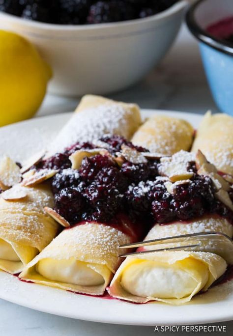 Delicate crepes with sweet creamy ricotta filling and tangy blackberry sauce make a marvelous breakfast. Surprise your family this weekend! #ASpicyPerspective #blintz #blintzpancakes #pancakes #rolledpancakes #jewish #blini #blackberrysauce #sweetcheese #crepe #crepes #sweetcrepe #breakfast #brunch Blintzes Recipe, Blackberry Sauce, Blackberry Recipes, A Spicy Perspective, Pancake Recipes, Crepe Recipes, What's For Breakfast, Pancakes And Waffles, Perfect Breakfast