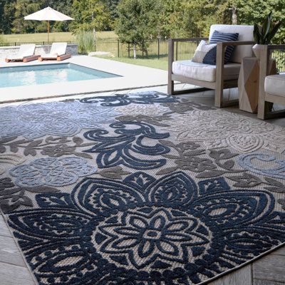 The high-low pile combined with the easy-care endurance of this colorful waterproof outdoor rug creates a relaxing space for your indoor or outdoor area. A modern lush tropical floral mandala pattern is fun and inviting. It is machine-made in Turkey from 100% polypropylene for lasting quality. This pile height allows it to fit under the door, making it an ideal rug for a bedroom or anywhere else. Suitable for both indoors and outdoors. This area rug would be a good fit for the family room, patio Waterproof Outdoor Rugs, Front Door Entry, Outside Area, Porch Balcony, Deck Porch, Relaxing Space, Porch And Balcony, Outdoor Rugs Patio, Floral Mandala