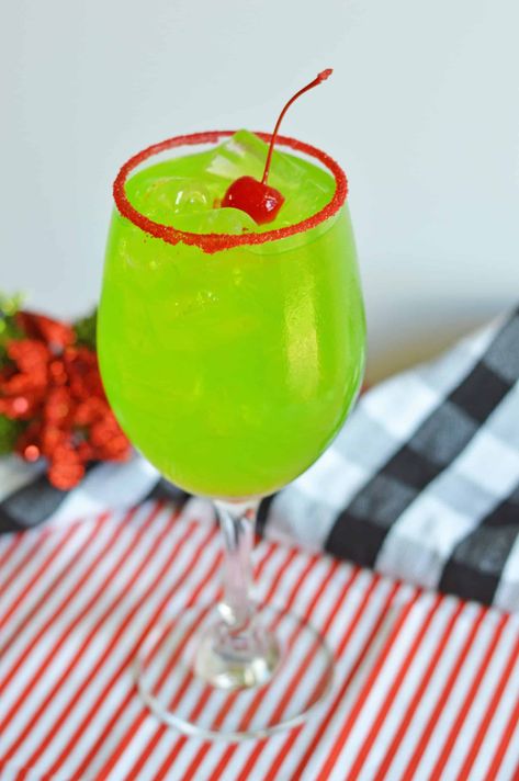 Revel in the holiday spirit with our Grinch Cocktail, a mixed drink that promises to invoke joy and festive cheer! This Christmas cocktail, bursting with vibrant colors and flavors, is precisely what you need to light up the season. Raise a toast and let the magic of Christmas get a whole lot merrier and brighter. Here's to unwrapping joy! Join us on this merry journey. Grinch Cocktail Recipe, Grinch Cocktails, The Grinch Cocktail, Grinch Cocktail, Grinch Drink, Grinch Punch, Christmas Cocktail, Vodka Drinks, Holiday Cocktail